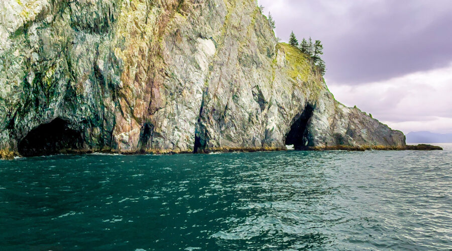 The rugged coastline of Alaska has many steep cliffs that are riddled with small and large caves.