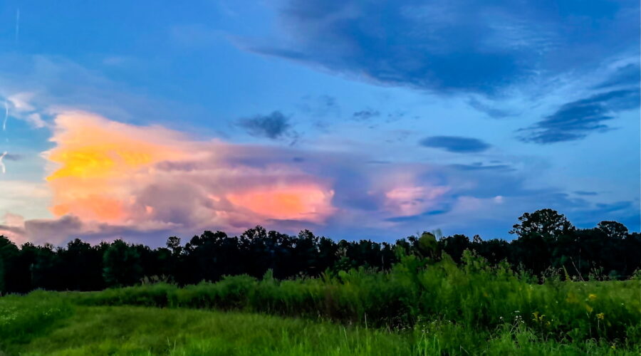The colors from the sunset are being reflected in the clouds of the eastern sky.
