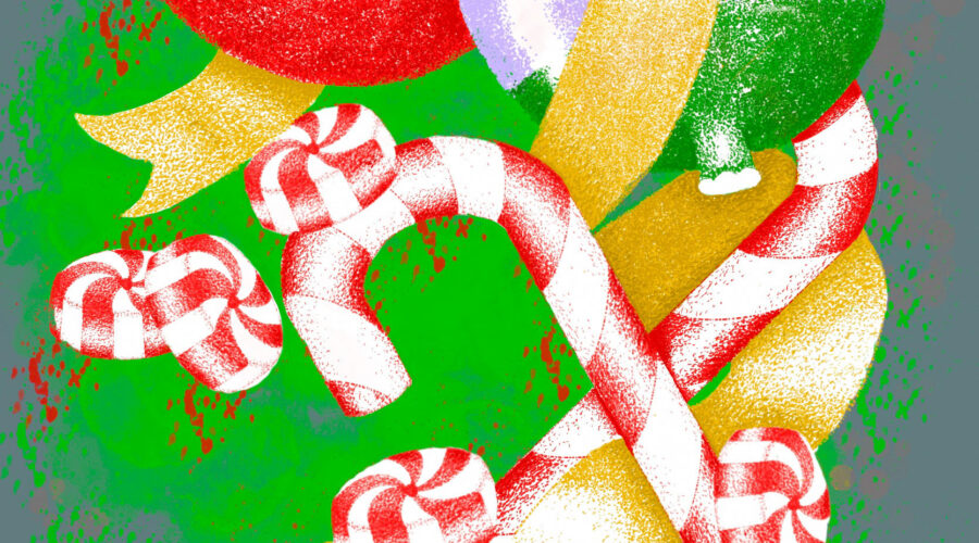 A selection of Christmas candy delights are wrapped up with two tree ornaments by a piece of ribbon.