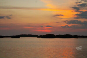 A colorful sunset at 7 pm by the water, makes one want to sit on the beach and relax the troubles of the day away.