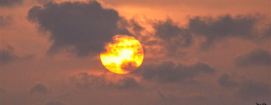 The sun begins to set over the water surrounding Cedar Key, Florida