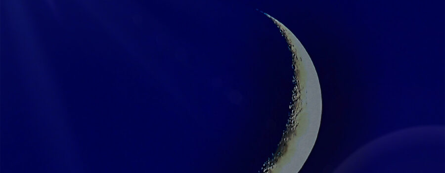A sliver of a moon is emphasized with some special light effects.