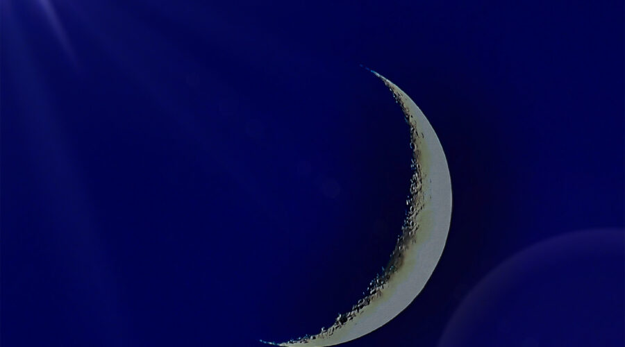 A sliver of a moon is emphasized with some special light effects.