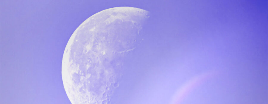 The late afternoon half moon is slightly hidden in a light mist that creates some interesting visual effects.