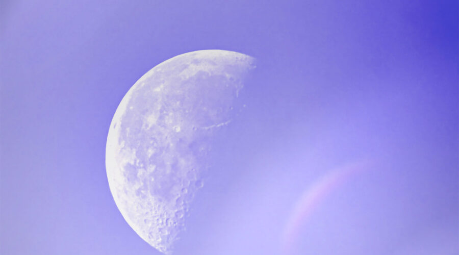 The late afternoon half moon is slightly hidden in a light mist that creates some interesting visual effects.