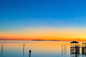 Beautiful deeps blues and bright oranges make up a simple but beautiful sunset over the waters of Cedar Key, Florida.