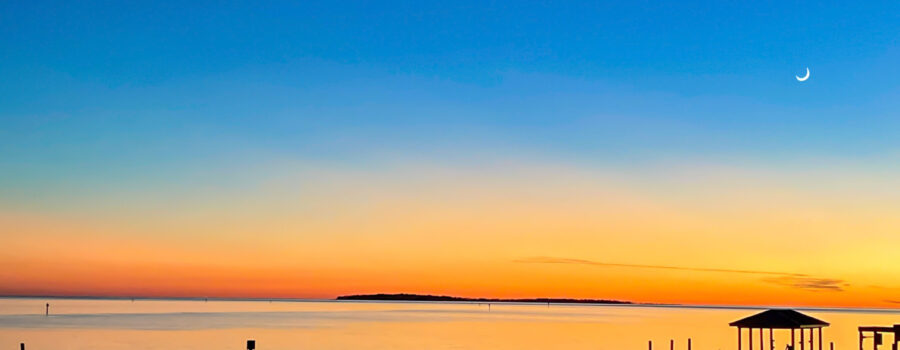 Beautiful deeps blues and bright oranges make up a simple but beautiful sunset over the waters of Cedar Key, Florida.