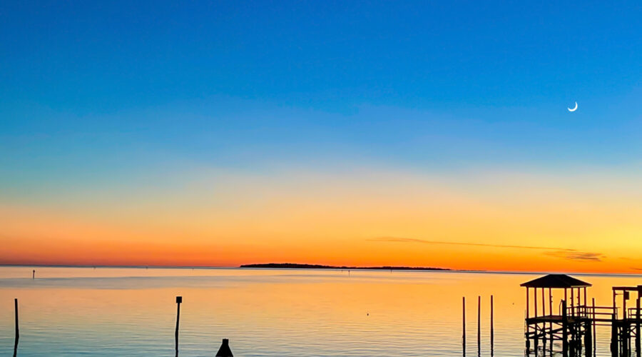 Beautiful deeps blues and bright oranges make up a simple but beautiful sunset over the waters of Cedar Key, Florida.